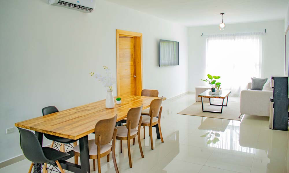 Dining room and living room in the penthouse at Beach Apartamentos in Playa Palmera